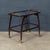An elegant Italian drinks trolley dating from the 1960s, combining a sculptural dark-stained wood frame with refined brass...