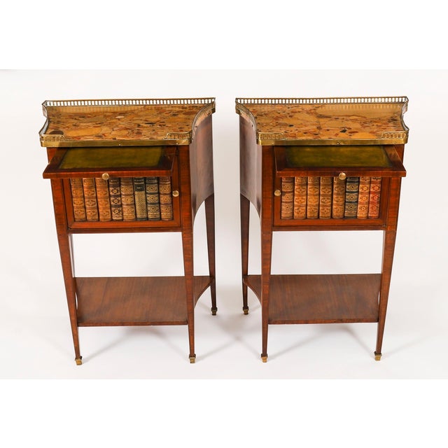 A thoroughly delightful pair of antique French walnut and tulipwood marble topped bedside cabinets, in the Louis XVI...