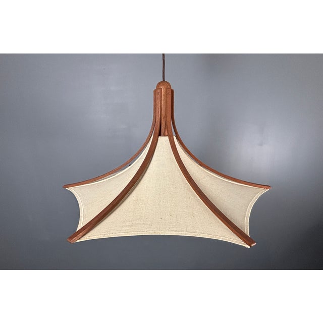 Teak and linen umbrella pendant by Domus, 1970s. This lamp is in great condition considering its age. The linen shade is...