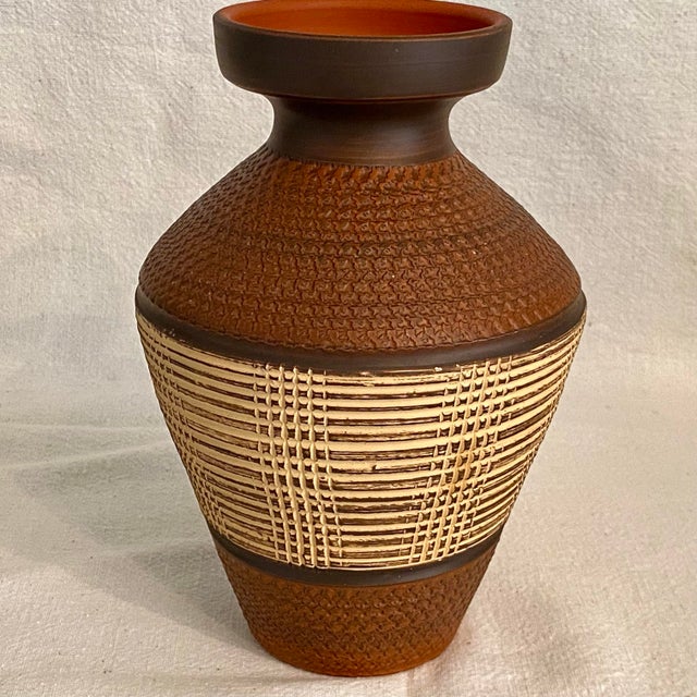Beautiful vase made in the 1950's in Germany. Red fired clay with intricate textures. The mark on the Bottom of the vase...