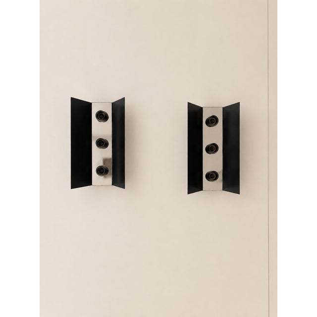 Pair of black and chrome metal wall sconces, made in France in the 1970s. Timeless geometric design, a beautiful mix of...