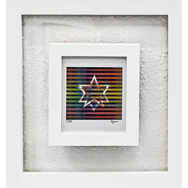 Agamograph (3D lenticular). Hand signed lower right by Yaacov Agam. Hand numbered 77/99 lower left Custom framed as...
