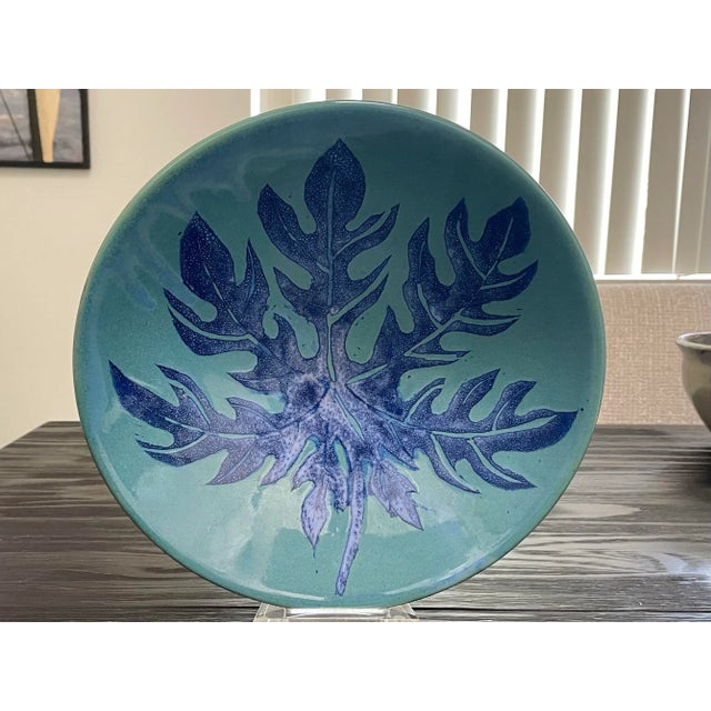 Vintage pottery bowl glazed in rich hues of blue, leaf design. Perfect for display, centerpiece or fruit. Dimensions:...