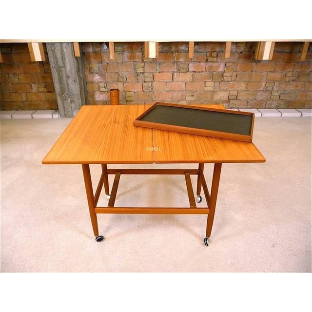 This tea trolley or serving cart was manufactured in Denmark during the 1960s. It is made from teak in a warm tone with a...