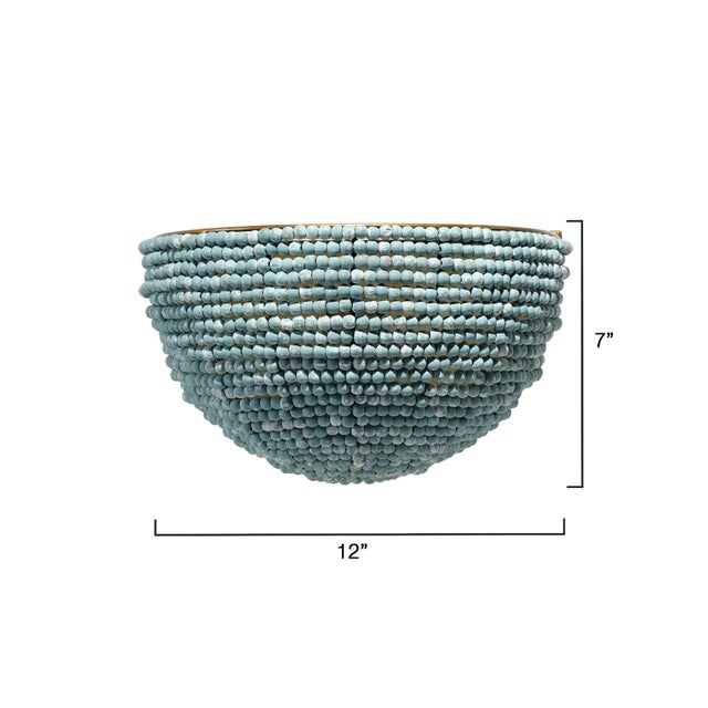 This decorative wall sconce shimmers with hand-carved blue mango wood beads, each individually finished so no two are...