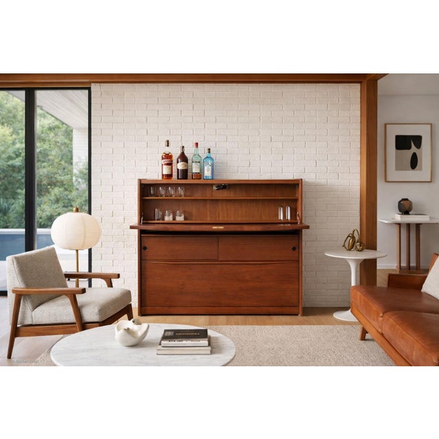 This mid-century modern walnut dry bar is a beautifully designed piece that blends clean modernist lines with thoughtful...