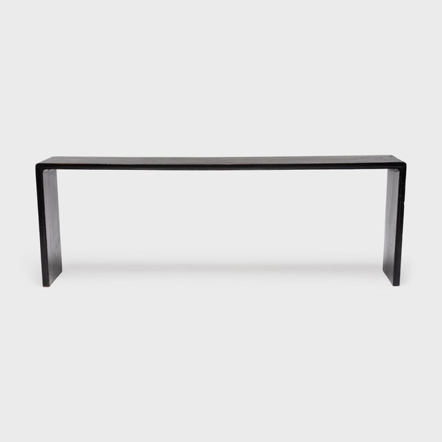 With no stretchers or spandrels, this slender console table flows as one continuous ribbon, rounding the bend with simple...