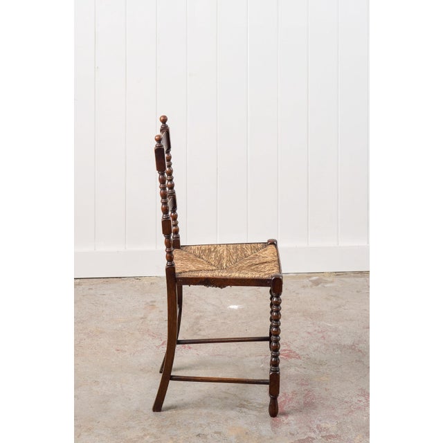 This petite bobbin chair features classic turned legs and ladder back detailing, while the handwoven rush seat adds a...