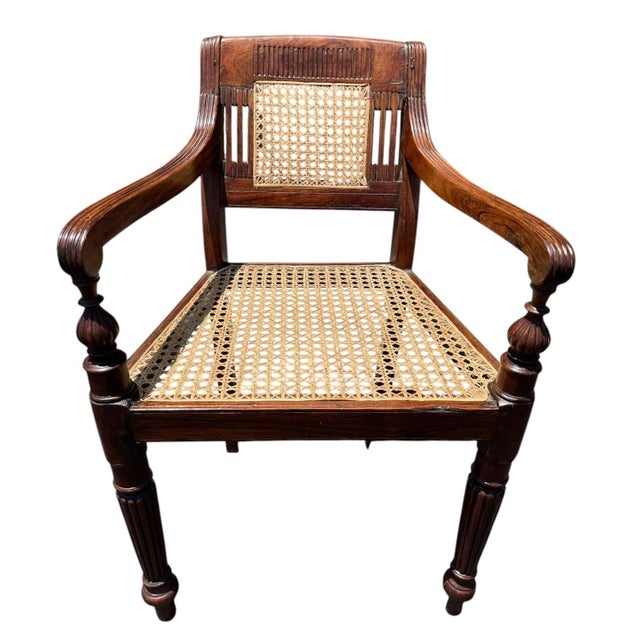 Pair of Antique Anglo-Indian styled carved armchairs with caning. These open armchairs combine English Regency design with...