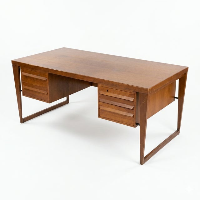 A refined example of Danish modern craftsmanship, this Kai Kristiansen teak desk dates to the 1960s and showcases the...