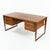 A refined example of Danish modern craftsmanship, this Kai Kristiansen teak desk dates to the 1960s and showcases the...