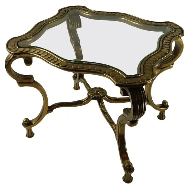 Mastercraft brass side table with scalloped rim. Rococo -inspired Italian design. Original glass top. Rectangular shaped...