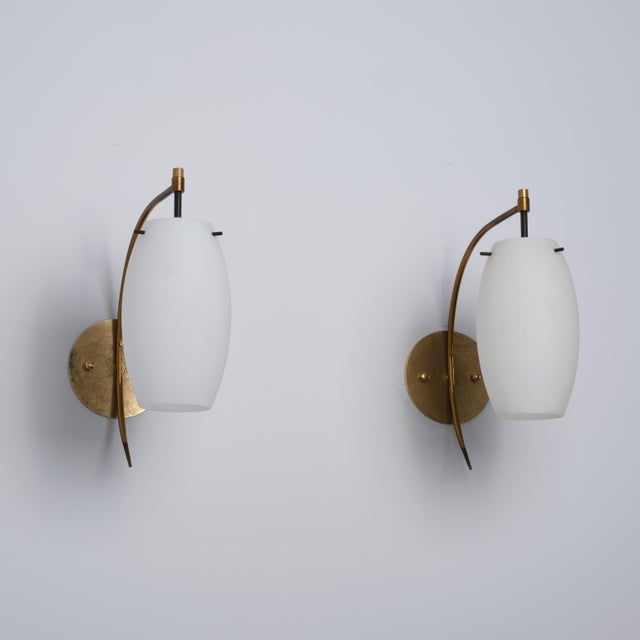 Pair of italian wall sconces dating from the 1950s, designed with an elegant and balanced mid-century composition. Each...