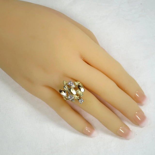 1960s Atlas 18k gold-plated cocktail ring. Tiered and stacked design of smooth and textured ovals, accented with small...