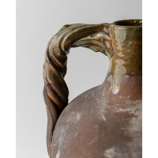 This antique 18th century terracotta amphora from Italy is a remarkable example of classical ceramic craftsmanship....