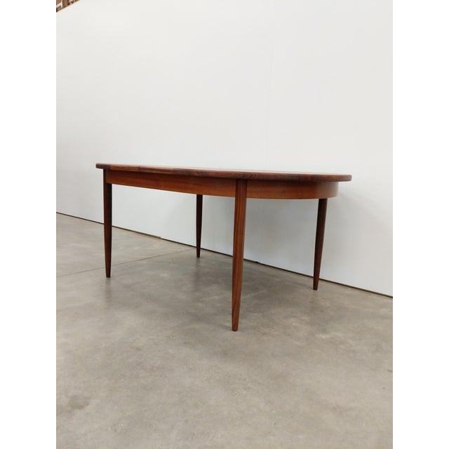 Authentic vintage mid century modern teak extendable dining table with built-in leaf. By G Plan. Maker's label on bottom...