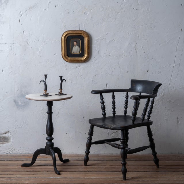 Captain's chair in our custom black finish with distressed patina, c.1880. Classic Victorian era barrel form with welled...
