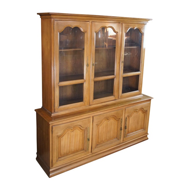 Circa 1970s Century Furniture Italian Provincial China Cabinet. Made from walnut with a stepback hutch featuring 3 shelves...