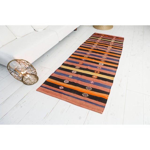 This is a vintage Turkish Oushak rug from the Mid 20th Century. The piece was hand-knotted.