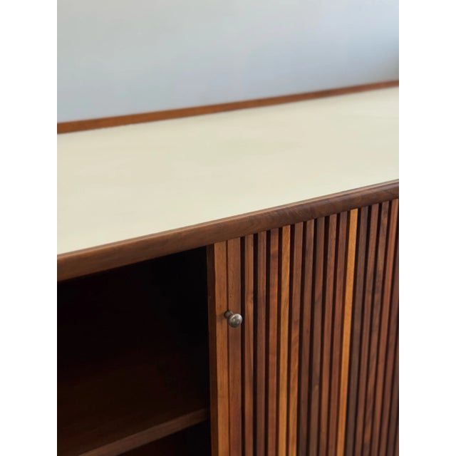 W66.25 D20 H29 Vintage credenza restored both structurally and aesthetically. Unit features sculptural legs, reeded...