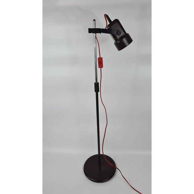 A vintage-style floor lamp with a movable reflector, dating back to the 1970s. It features a modern design from that...