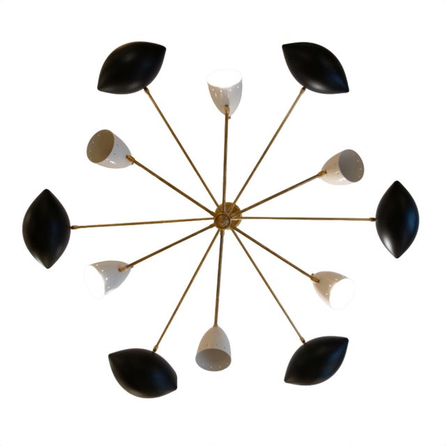 A brass ceiling lamp in gold with black and white shades arranged on two levels. Designed in Italy, these 1970s-style...