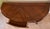 Polished wood console table has a demilune shape with a chevron veneer pattern on the top surface. The piece includes a...