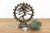 A masterfully cast mid-scale devotional sculpture capturing a stylized sacred figure, boasting a radiant, sun-warmed aged...