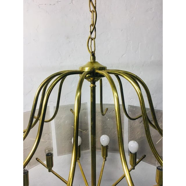 Gold-colored, 12-burner copper chandelier with smoked glass panels with polished edges. Elegant, clean design that...