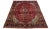 Vintage hand-knotted wool rug with red field and medallion motif with multicolor hues. This rug measures 6'6' x 9'7'.