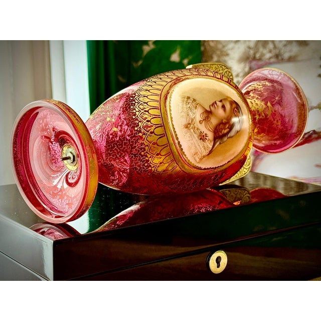 A decorative late 19th century Bohemian ruby glass urn vase, attributed to Moser. This refined piece features a hand-...