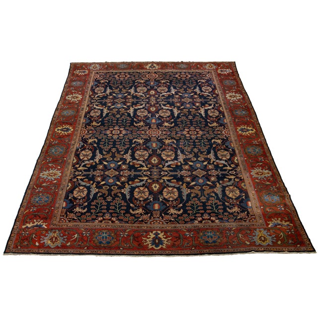 This 1880s antique Sultanabad wool rug features a navy blue field with multicolor accents in an all-over floral design,...