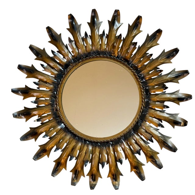 Round wrought iron sunburst mirror from the 1950s. Italian handcrafted, decorated with leaves.