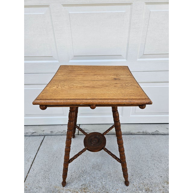 This cute side tables features a stick and ball apron just under the tabletop. The table features turned legs and a carved...