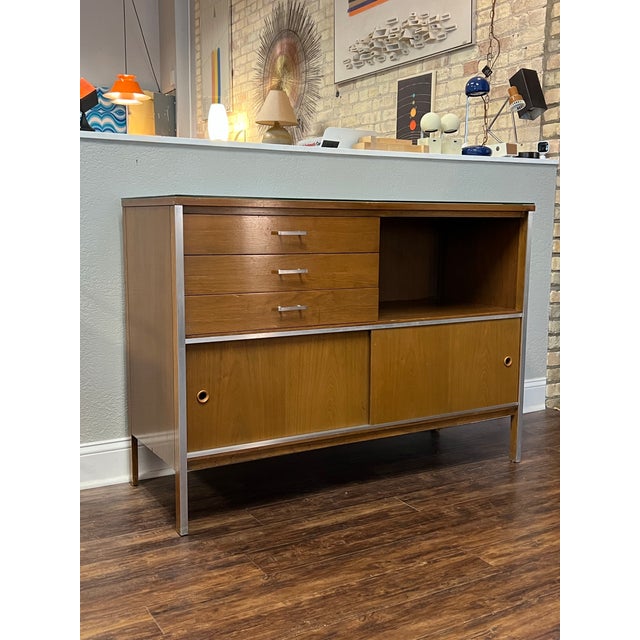 Mid-century modern credenza or media cabinet designed by Paul McCobb for his Linear Group line for Calvin Furniture. It...