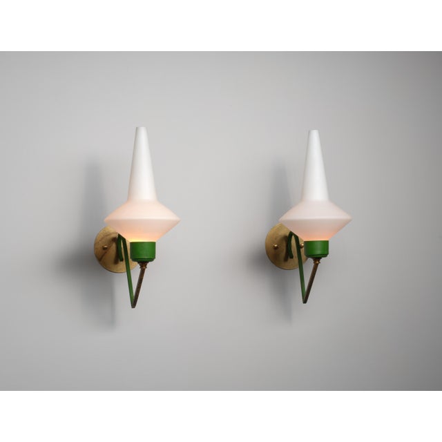 Produced in Italy during the 1950s, this large pair of wall‑mounted lights combines a circular brass backplate—12 cm (4.72...
