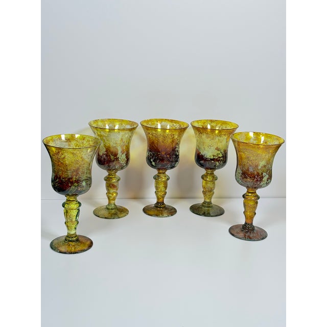 A luminous set of art glass goblets. The wide flair rims, thick sculptural stems and rounded bases give these pieces a...