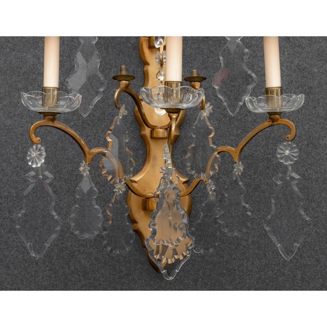 Regency Style Brass Five-Light Sconce, with scroll arms and drop prism crystals. 24.75" H x 22.5" W x 11.5" D. Provenance:...