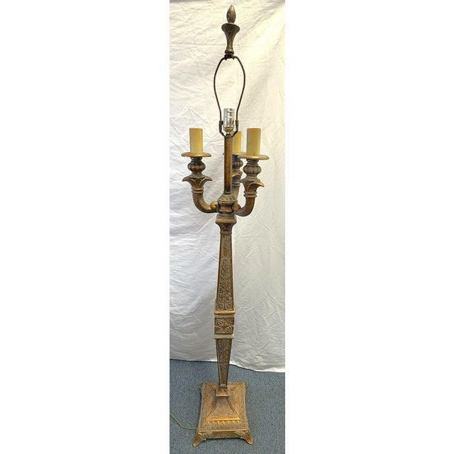 Stately vintage metal floor lamp from the mid 20th century. It is made of heavy metal in a Victorian torchiere style and...