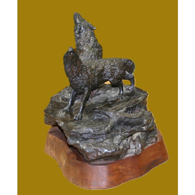 A beautifully done sculpture of a pair of wolves sitting on a wooden plinth Name tag is D. Kennicutt. I have not been able...