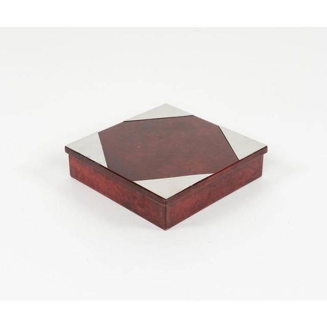 Midcentury beautiful squared box in red goatskin, wood and chrome details attributed to the Italian designer Aldo Tura....