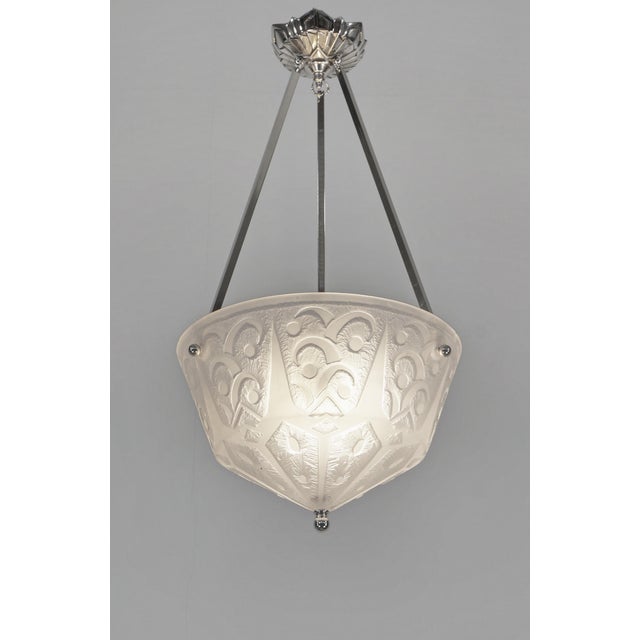 DAUM A rare French 1925-1930 art deco chandelier in nickel plated solid brass or bronze holding a deep bowl by Daum. The...