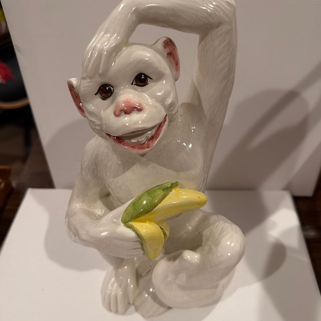 This vintage Italian glazed ceramic monkey figurine brings exactly the kind of playful sophistication collected rooms...