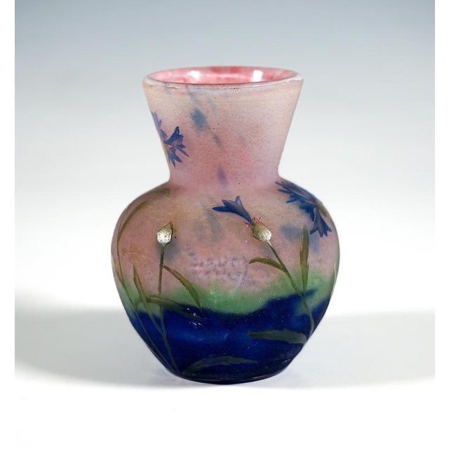 Small baluster vase, with a bulbous body resting on a flush base, featuring a flared, funnel-shaped neck; colourless glass...