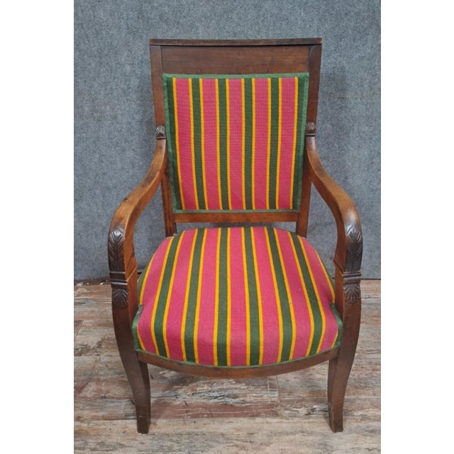 An Empire period walnut office chair, featuring a clean and elegant design characteristic of the early 19th century. The...