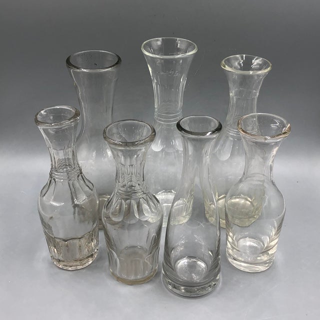 This set of seven antique carafes impresses with its elegant simplicity and timeless appeal. The bottles vary in shape and...