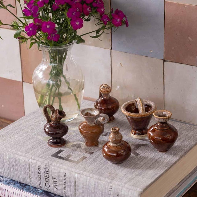 Beautiful collection of 6 vintage glazed miniature ceramics from France, 1950s. Varying shapes and sizes in a shiny brown...