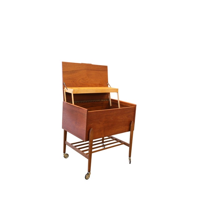 Charming and very useful Danish sewing cart in teak with smart storage and practical details. A versatile piece of...