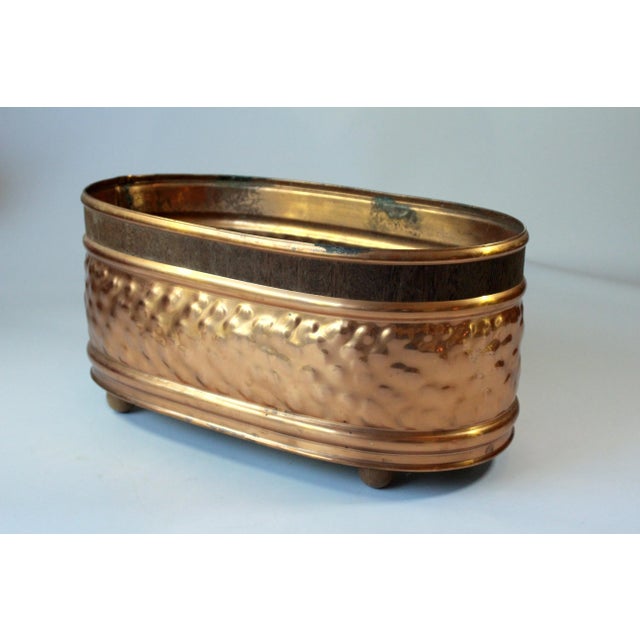 Mid Century copper jardiniere - planter - with a brass bottom and wooden feets - in good vintage condition with traces of...