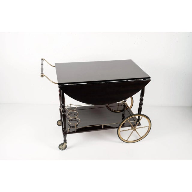 Beautiful bar cart by Maison Bagues (attr.) in mahogany wood and brass.